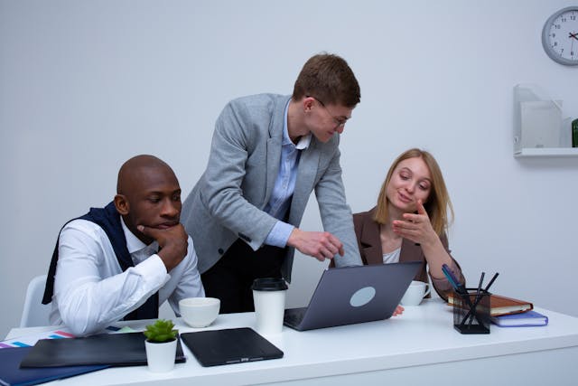 three real estate experts looking at a computer